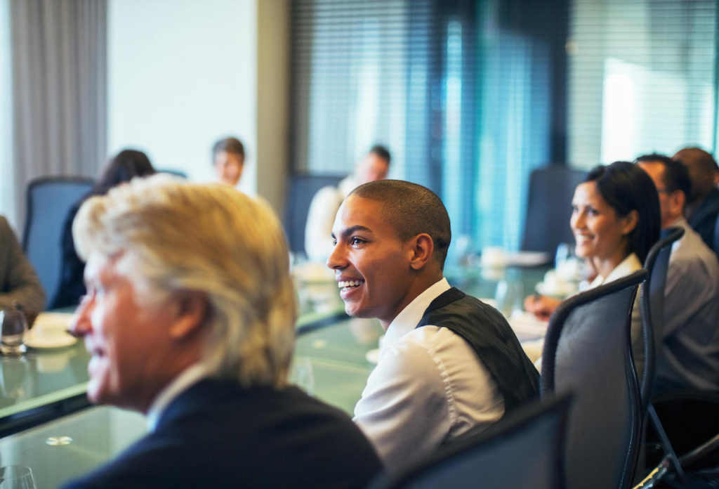 Smiling businessman attending business meeting in conference room. Image shot 2014. Exact date unknown.